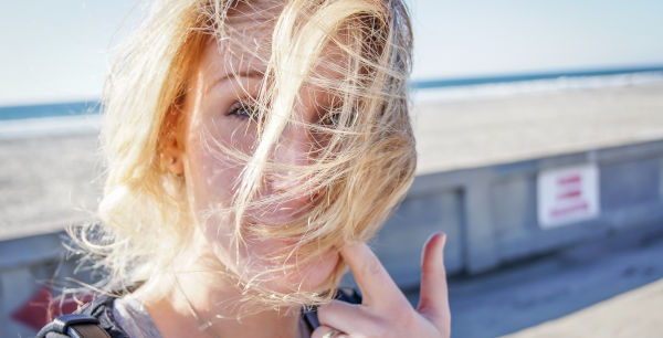 Woman with her hair blown over her face