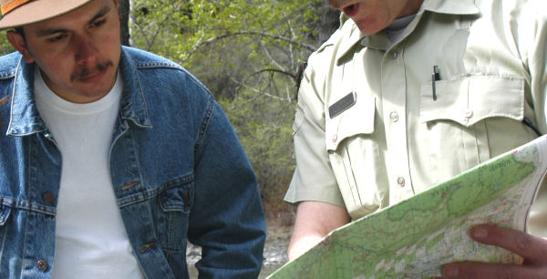 A man being shown directions on a map