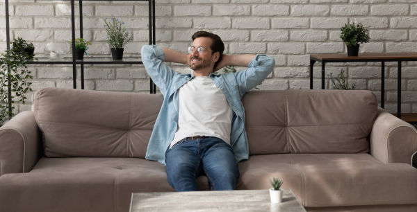 a man sitting contentedly on a couch