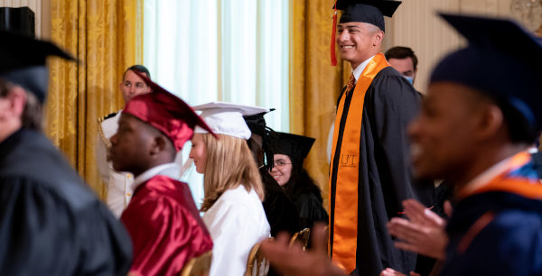 gowned and hatted graduates at a ceremony