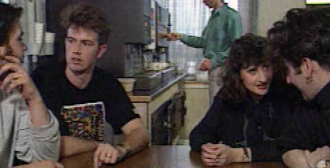 a group of young people sitting at a table