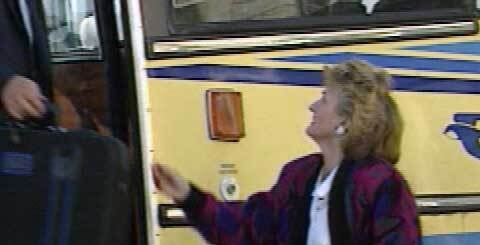 woman standing at the door of a coach