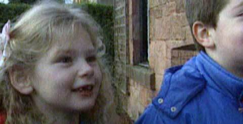 a young girl outside a house