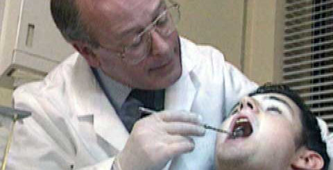 A man with mouth open in a dentist's chair