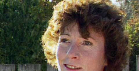 close-up of a smiling woman with curly hair