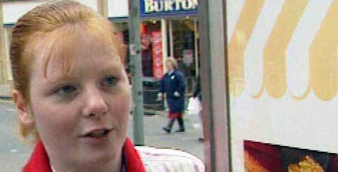 young red-haired girl outside a shop