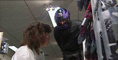 man in motorcycle helmet and a shop assistant